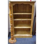 A farmhouse pine freestanding bookshelf;