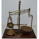 A Victorian Cooperative Wholesale Society Limited balance scale and weights, mahogany base,