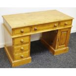 A pine twin pedestal desk, moulded top above three frieze drawers,