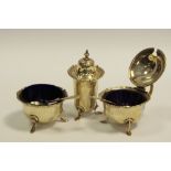 A silver cruet set of salt, mustard and pepper pot,