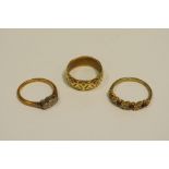 An 18ct gold wedding band 3.6g; an illusion set three stone 9ct gold ring; another 9ct gold ring, 3.