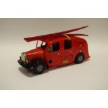 A Tri-ang Minic Fire Engine red body with two red plastic ladders, brass bell, metal hubs,