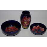 Moorcroft- a baluster shaped miniature vase; a Hibiscus pattern bowl,