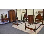 A walnut bedroom suite, comprising wardrobe, chest of five drawers, bedside cabinet, two bed frames,