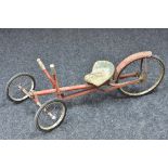 A mid 20th century hand powered, foot steering low tricycle, red livery, c.