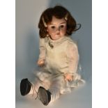 A Max Handwerk bisque head doll, composition body, jointed limbs, brown wig, open eyes,