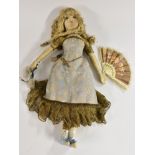 An Early 20th century hand made cloth doll, painted and stitched features,