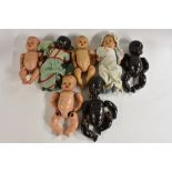 Dolls - an early 20th century composite baby doll, painted eyes, closed sneering mouth,