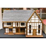 A large scratch built two storey Tudor cottage dolls house,