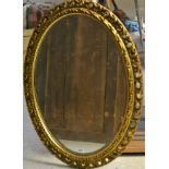 An oval 'gilt' framed mirror,