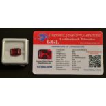 A loose rectangular emerald cut corundum ruby, measuring 11.68mm x 8.85mm x 6.