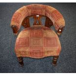 A Victorian mahogany club armchair, curved cresting rail, stuffed over upholstery,