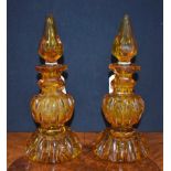 A pair of 19th century Bohemian amber glass baluster scent bottles,