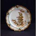 Derby Crown Porcelain Company shaped circular plate, decorated with gilt foliage on a lemon ground,