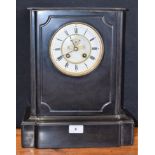 A Victorian black marble clock, Roman numerals, twin winding holes,