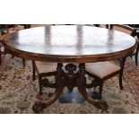 A 19th century walnut table, the well figured veneered oval top supported by four pillars,