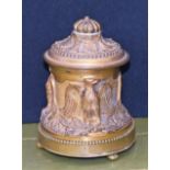 A 19th century ormolu inkwell, cast in relief with eagles, hinged cover, bun feet, 13cm high, c.