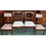 A pair of Edwardian mahogany inlaid nursing chairs;