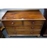 A Victorian mahogany chest of two short drawers over two long turned handles and feet