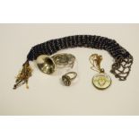 An enamelled pendant locket; an Italian silver French horn;