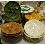 A large scallop serving plate in green and white; seven matching smaller dishes;