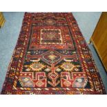 A Luri carpet, geometric designs in orange, indigo,