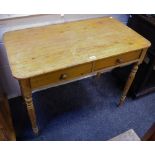 A pine country kitshen table, rounded rectangular top, two short drawers to frieze,