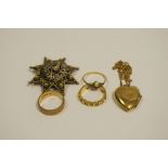 A 9ct gold heart locket; a 9ct gold dress ring; a filigree star brooch,