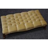 A Victorian footstool, buttoned upholstery, cabriole legs, c.