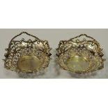 A pair of 19th century white metal sweet meat baskets, pierced throughout, shell and scroll border.