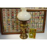 Cigarette Cards - A brass oil lamp; a book, Discovering Oil Lamps; a framed set of cigarette cards,