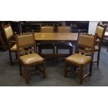 A country kitchen oak refectory style table, shaped uprights; four oak dining chairs,