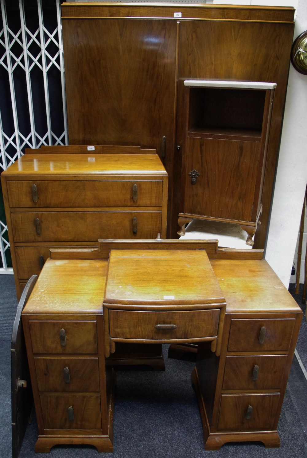 A 1930/40's walnut bedroom suite comprising double wardrobe, dressing table with triptych mirrors,