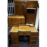 A 1930/40's walnut bedroom suite comprising double wardrobe, dressing table with triptych mirrors,