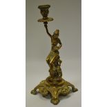A 19th century candlestick in the form of a scantily clad caryatid in the Etruscan taste raised on