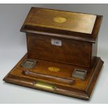 An Edwardian Sheraton Revival desk stand, vacant brass cartouche,