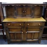 An oak court cupboard by The John Walsh manufacturing Ltd; two door cupboard to top,