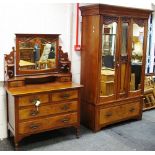 An art nouveau walnut veneered double wardrobe, ogee cornice, two mirrored doors,