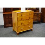 A Victorian pine chest of two short drawers over three graduated long turned handles and feet