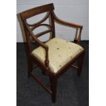 A Regency mahogany open arm chair, curved top rail, x frame splat, outswept reeded arms,