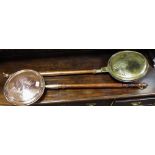 A brass and copper warming pan;