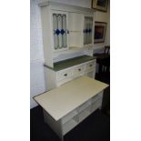 A painted kitchen sideboard, moulded cornice above a pair of glazed doors,