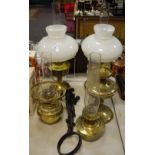 A Miller and Son wall mounted brass oil lamp; Two Aladdin 23 oil lamps;