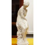 A plaster figure of a seated maiden