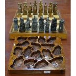 A cased chess set with carved stone figures;