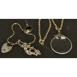 A silver magnifying glass necklace; a padlock bracelet; scent funnel;