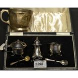A silver Christening mug, Birmingham 1907; a silver plated three piece cruet set,