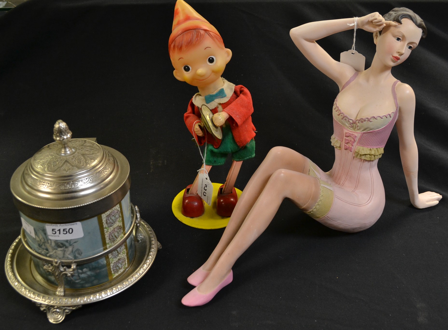 A Japanese tin plate and plastic clockwork Pinocchio automaton; a decorative biscuit barrel,