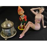 A Japanese tin plate and plastic clockwork Pinocchio automaton; a decorative biscuit barrel,
