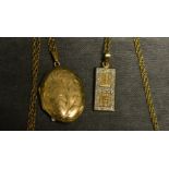 A 9ct gold pendant, Chinese design, diamond chip set; a 9ct gold locket and chain,